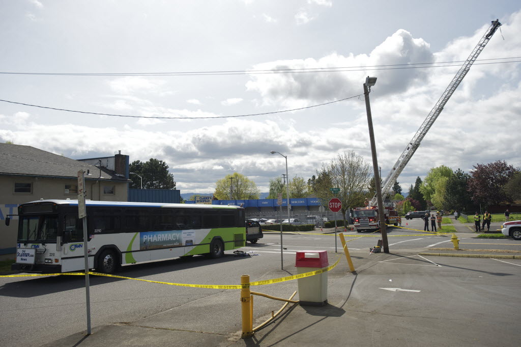 With the help of the Vancouver Fire Department's ladder truck, police investigate a fatal accident involving a C-Tran bus and a bicyclist in April 2012.