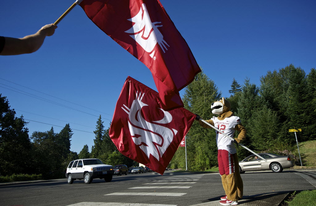 Washington State University mascot Butch T. Cougar greets traffic coming onto the Salmon Creek campus this morning.