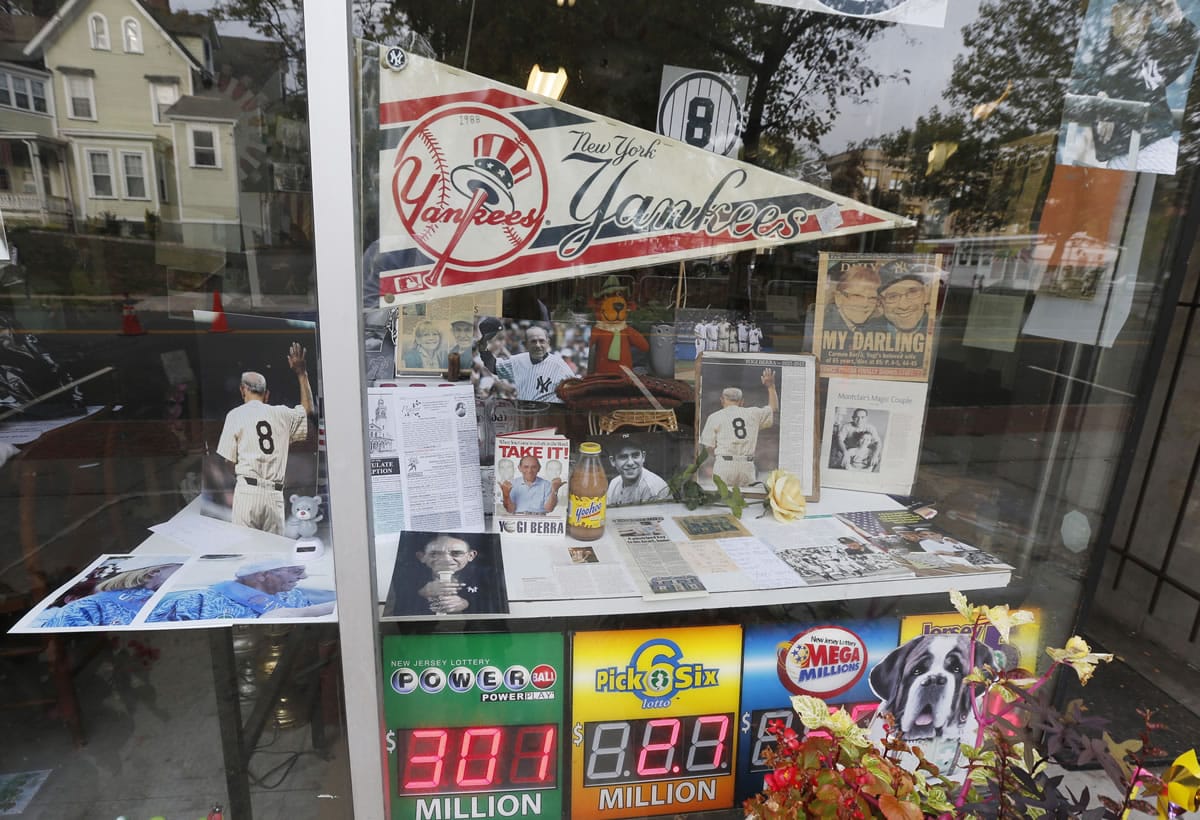 Memorabilia of New York Yankees Hall of Fame catcher Yogi Berra is on display at a store near the  Church of the Immaculate Conception before funeral services for the late baseball star Tuesday in Montclair, N.J. The baseball legend known for his quirky sayings died Sept. 22. He was 90.