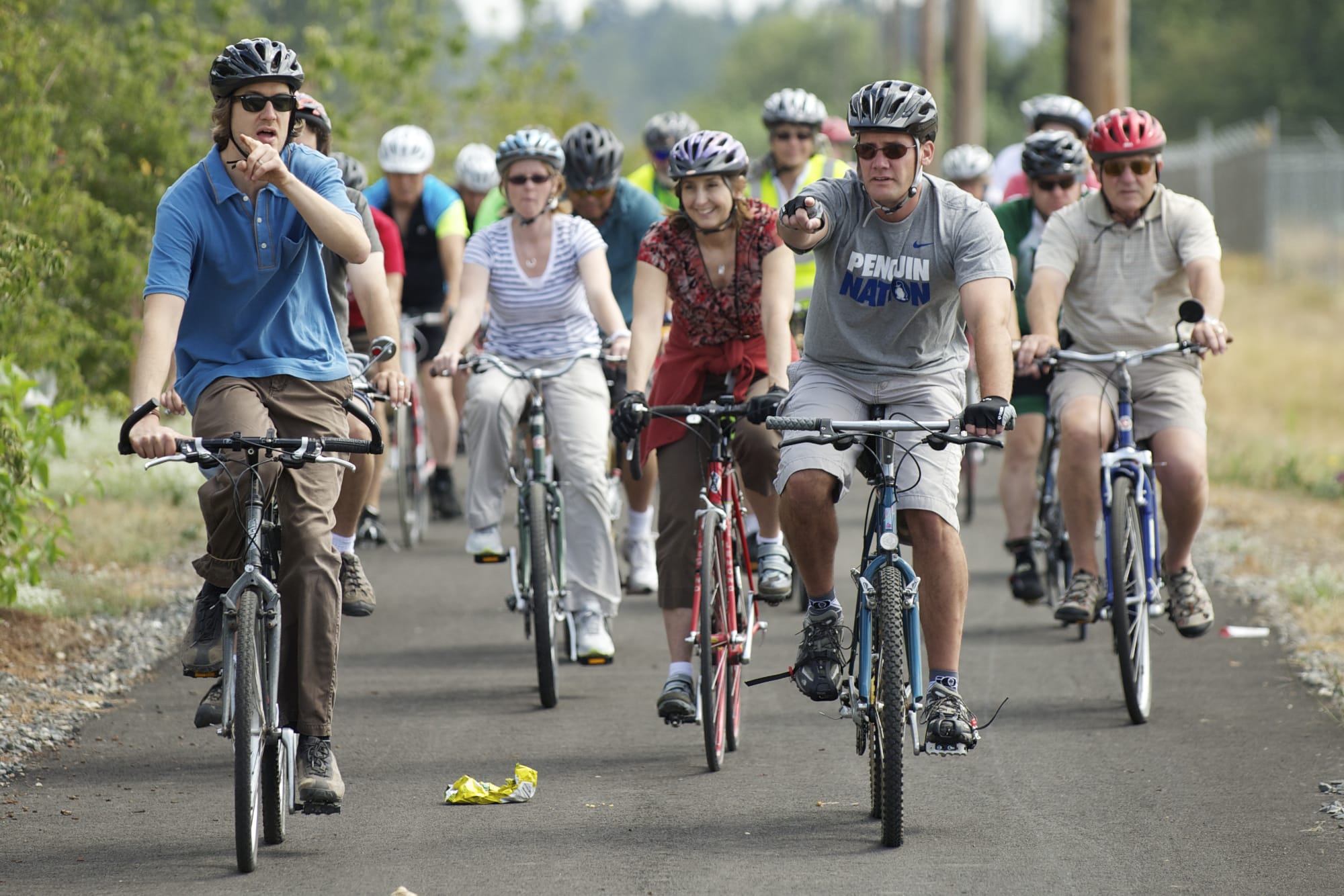 In this Columbian file photo from summer 2013, Arnada neighborhood resident Todd Bachmann, left, and Vancouver Mayor Tim Leavitt lead a bike rally to publicize the need for safer cycling along Lower River Road.