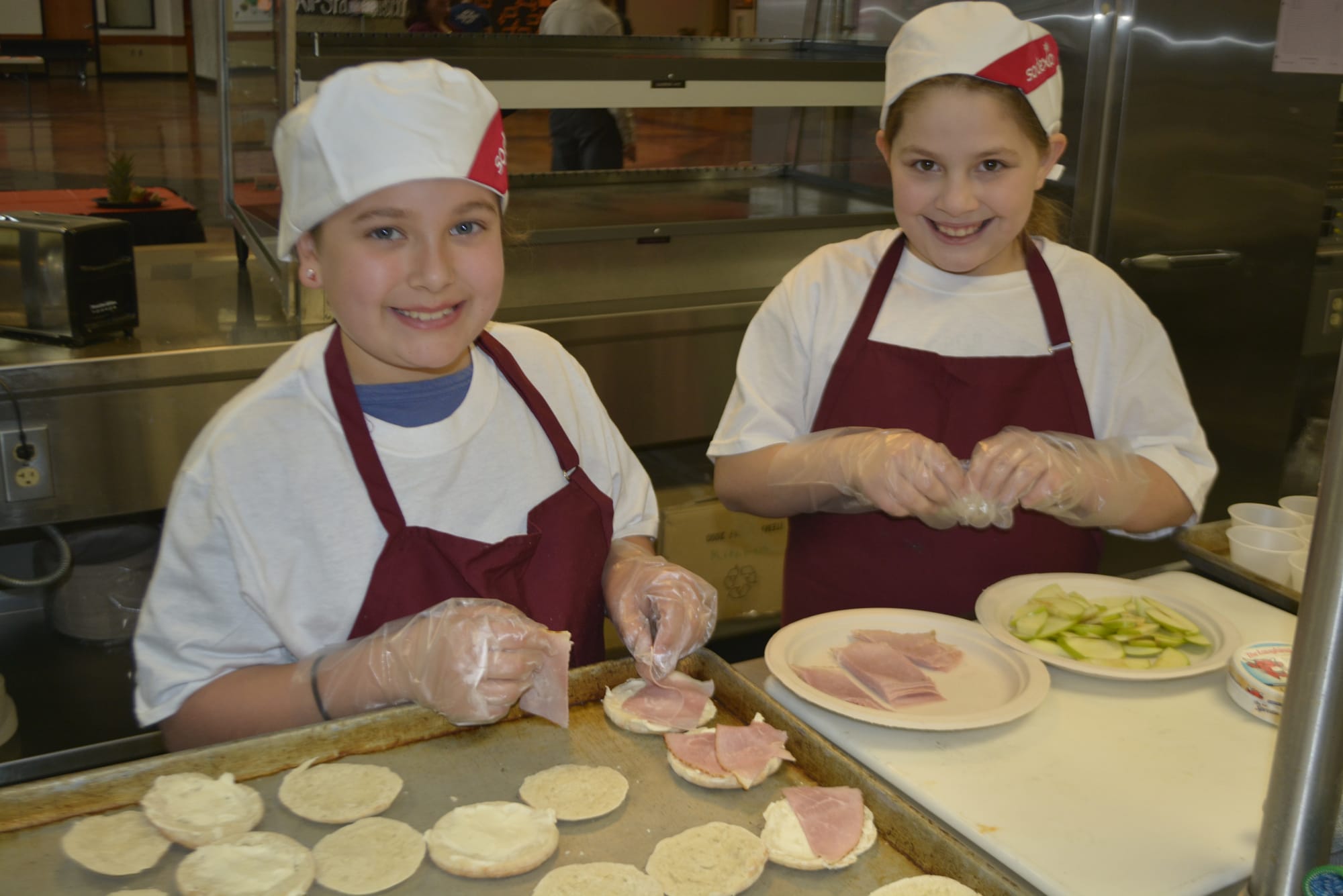 Washougal: Hathaway Elementary School student Danielle Melton, left, and Gause Elementary School student Mackenzie Mills take part in a live cooking competition March 13, 2014, at Washougal High School.