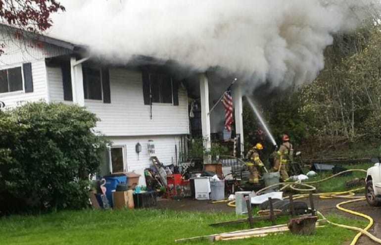 Firefighters work on extinguishing a fire at a home near Lewisville Park.