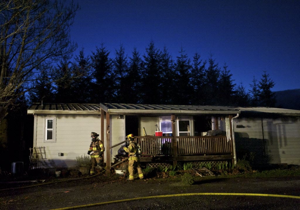 Crews respond to fire at 5302 N.E. 239th St. west of Battle Ground on Wednesday evening. Flames and smoke caused significant damage to the double-wide manufactured home, a fire official said.