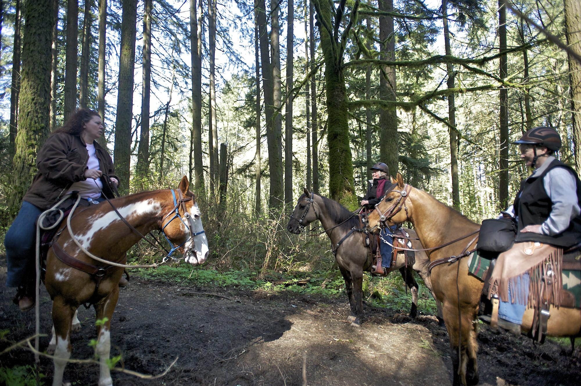 From left, Bobbi Luper, Anita Will and Betty Espey ride the Whipple Creek Park Trail on March 22.