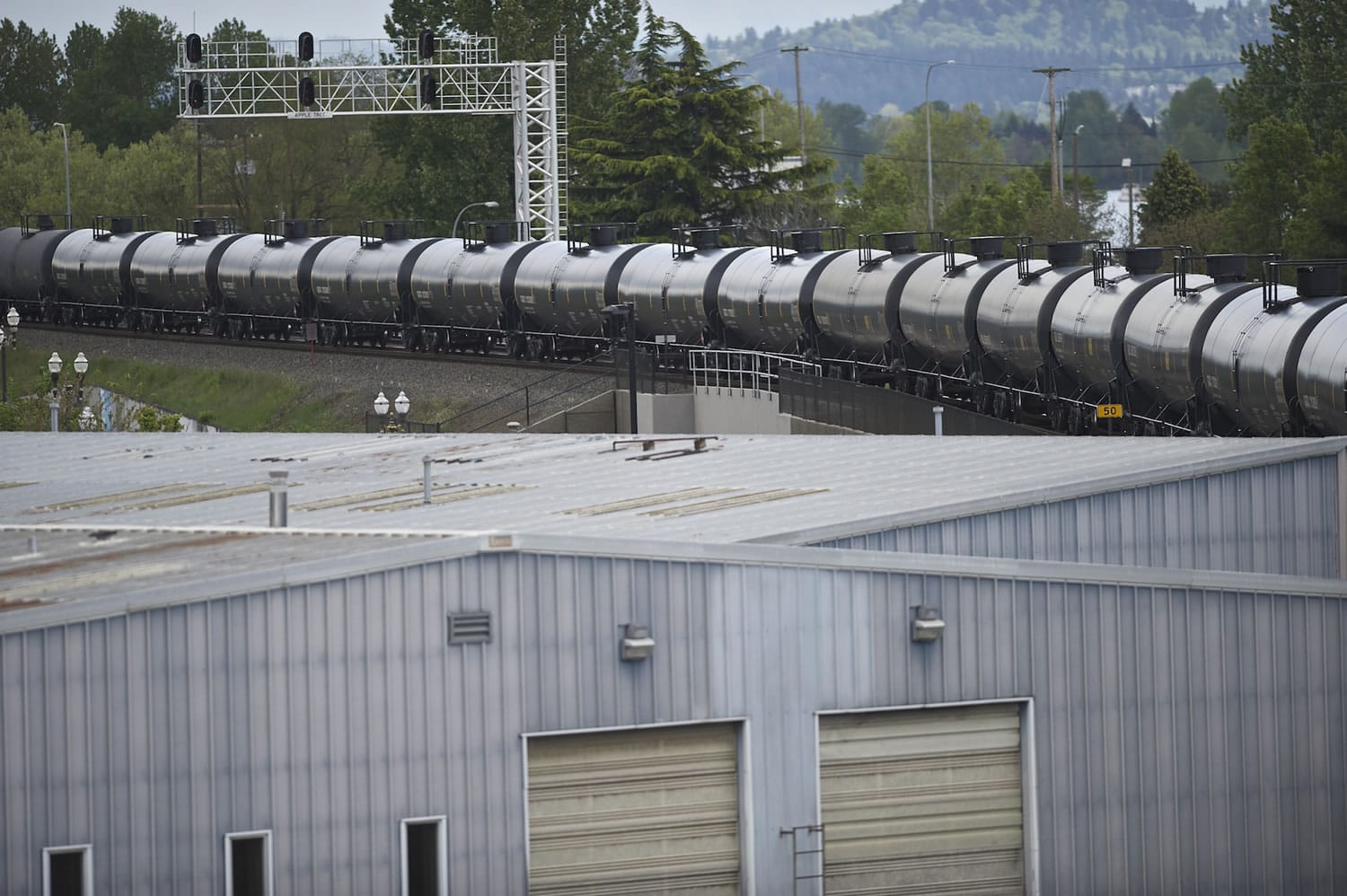 A train with tanker cars passes through downtown Vancouver on Friday.(Zachary Kaufman/The Columbian)