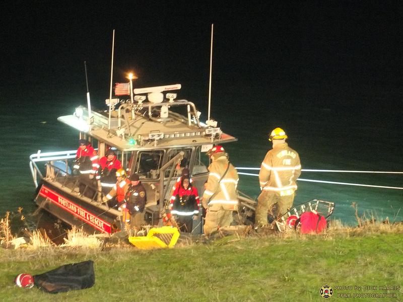Portland firefighters work to recover the body of a motorist who plunged into the Columbia River from Marine Drive on Wednesday evening.
