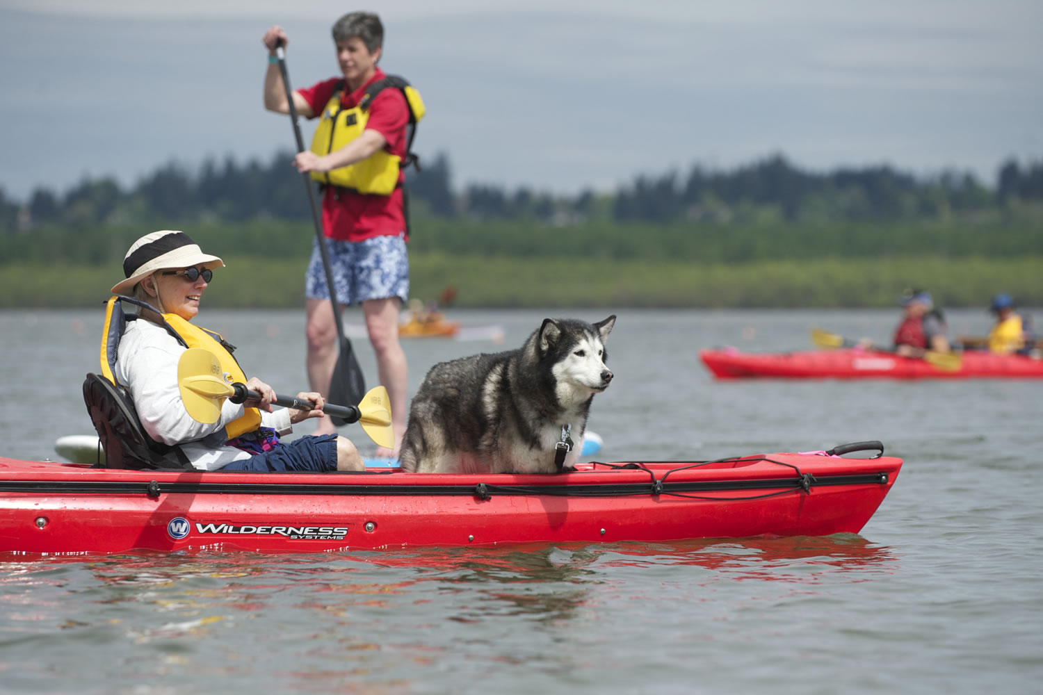 Cathy Kwapinski and her 11-year-old dog, Huskers, try out a kayak at the Spring Paddle Festival at Vancouver Lake.
