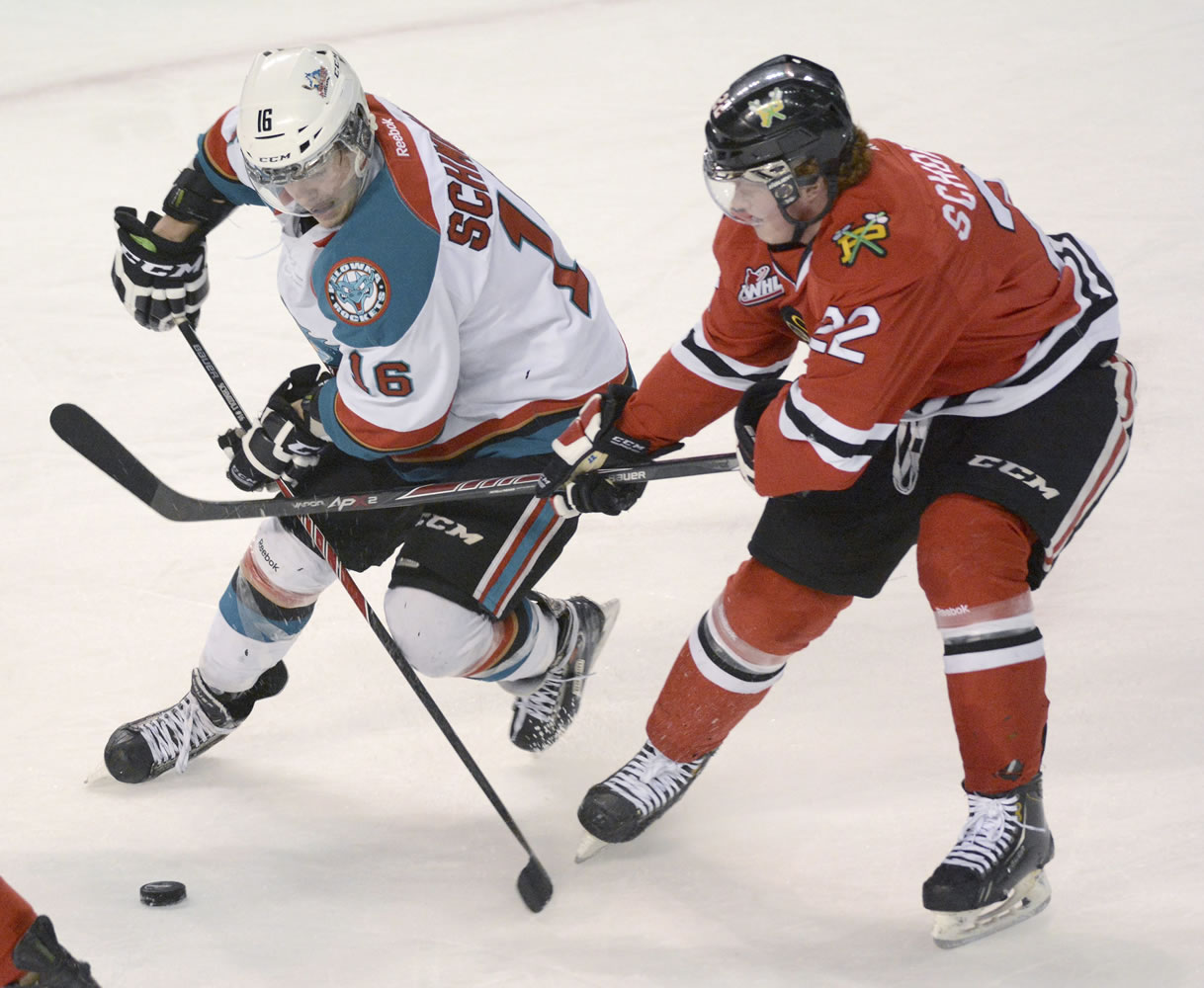 Kelowna Rockets Kris Schmidli, battles for the puck along with Portland Winterhawks, Alex Schoenborn during WHL playoff action at Prospera Place on Friday evening.