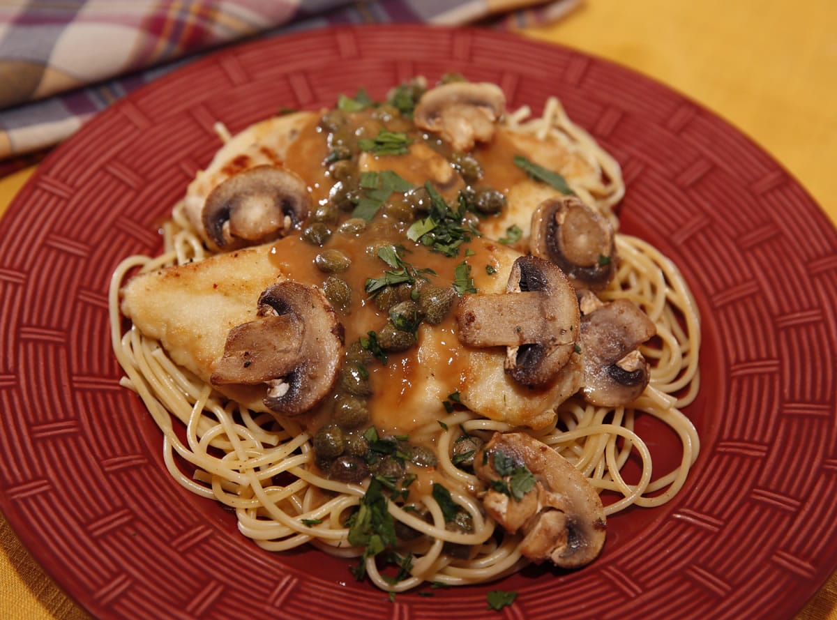 Chicken Piccata can be plated over spaghetti for an easy weeknight meal.