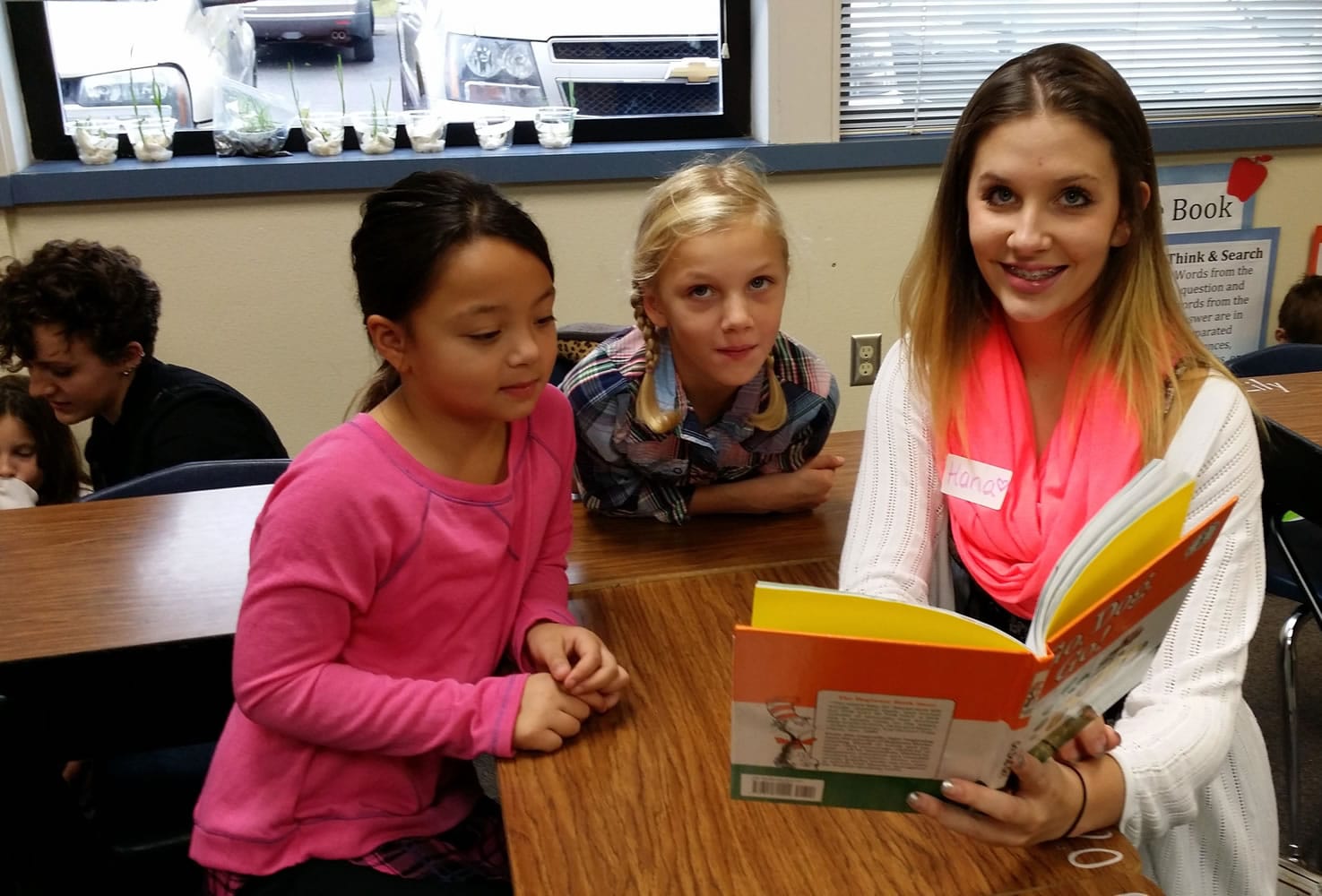Gause Elementary School students Jayda Peterson and Avery Price read with Hana Nekvapil, a student in the WHS child development class.