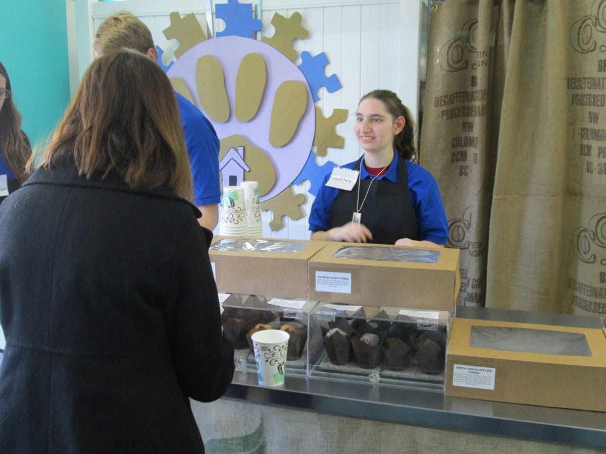 Aubrey Fasano assists a customer with coffee at Transition Perks in Western Springs, Ill.