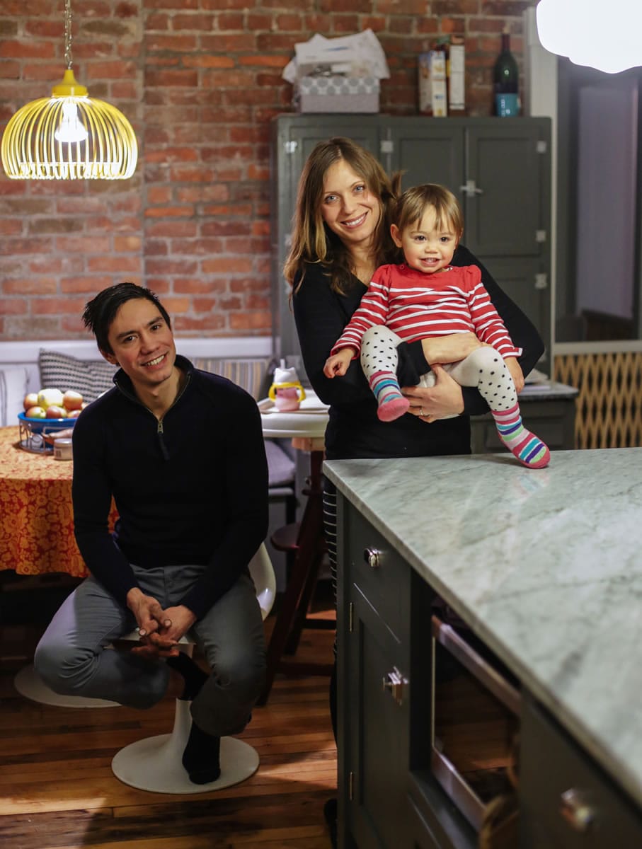 Chris Lee poses for a photo with his wife Amy Feigley-Lee and their child Ruby Lee in their redone kitchen after being part of the DIY Network's &quot;American Rehab: Detroit&quot; show.