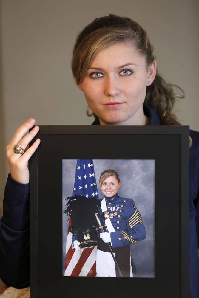 Savannah Emmrich holds her senior portrait in her dress uniform on Monday, Dec. 22, 2014 in Plainfield, Ill. Emmrich is a cadet lieutenant colonel regimental executive officer at The Citadel, The Military College of South Carolina.  She is one of the only female students  to hold the cadet regimental command position.