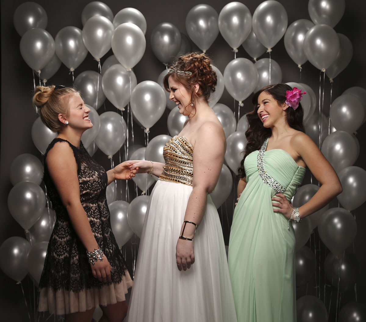 Kali Mann, from left, Sophie Heyman, and Emilee Hassanzadeh don prom looks at the Mall of America in Bloomington, Minn.