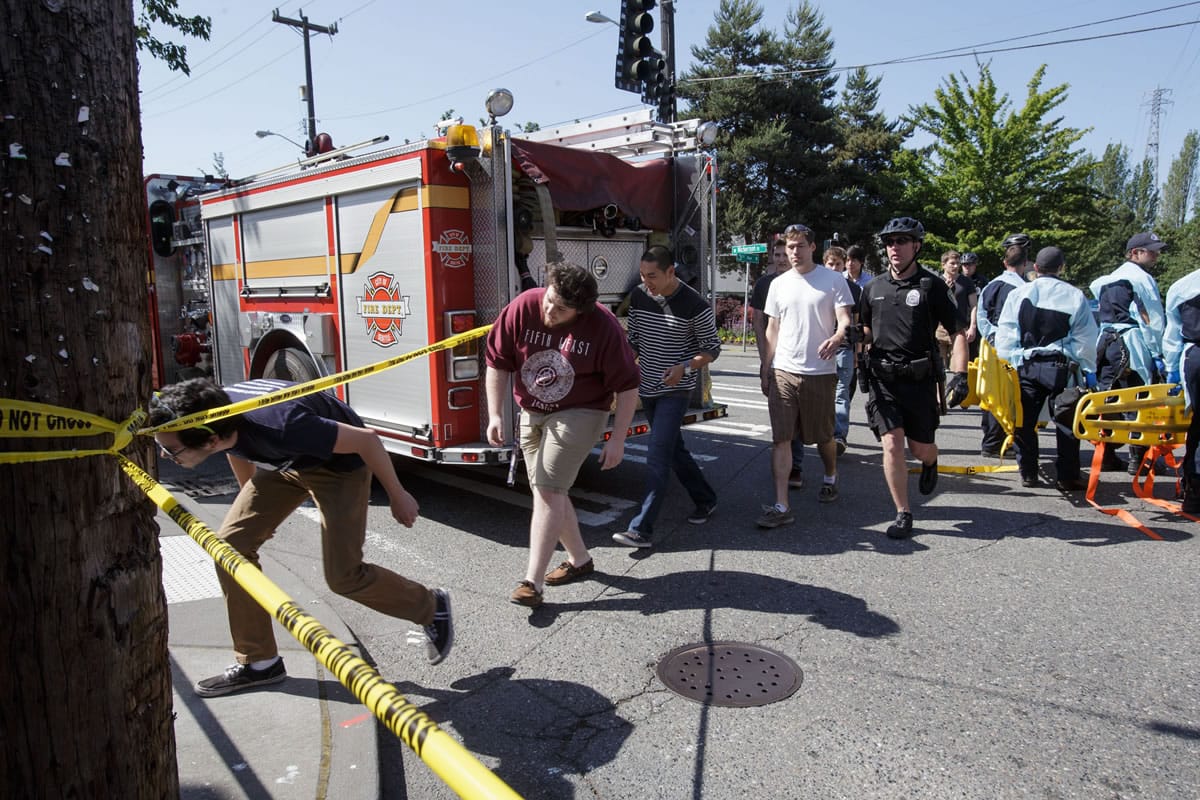 Seattle Pacific University students are lead out of the crime scene area after a shooting occurred on the university&#039;s campus Thursday, June 5, 2014, in Seattle.