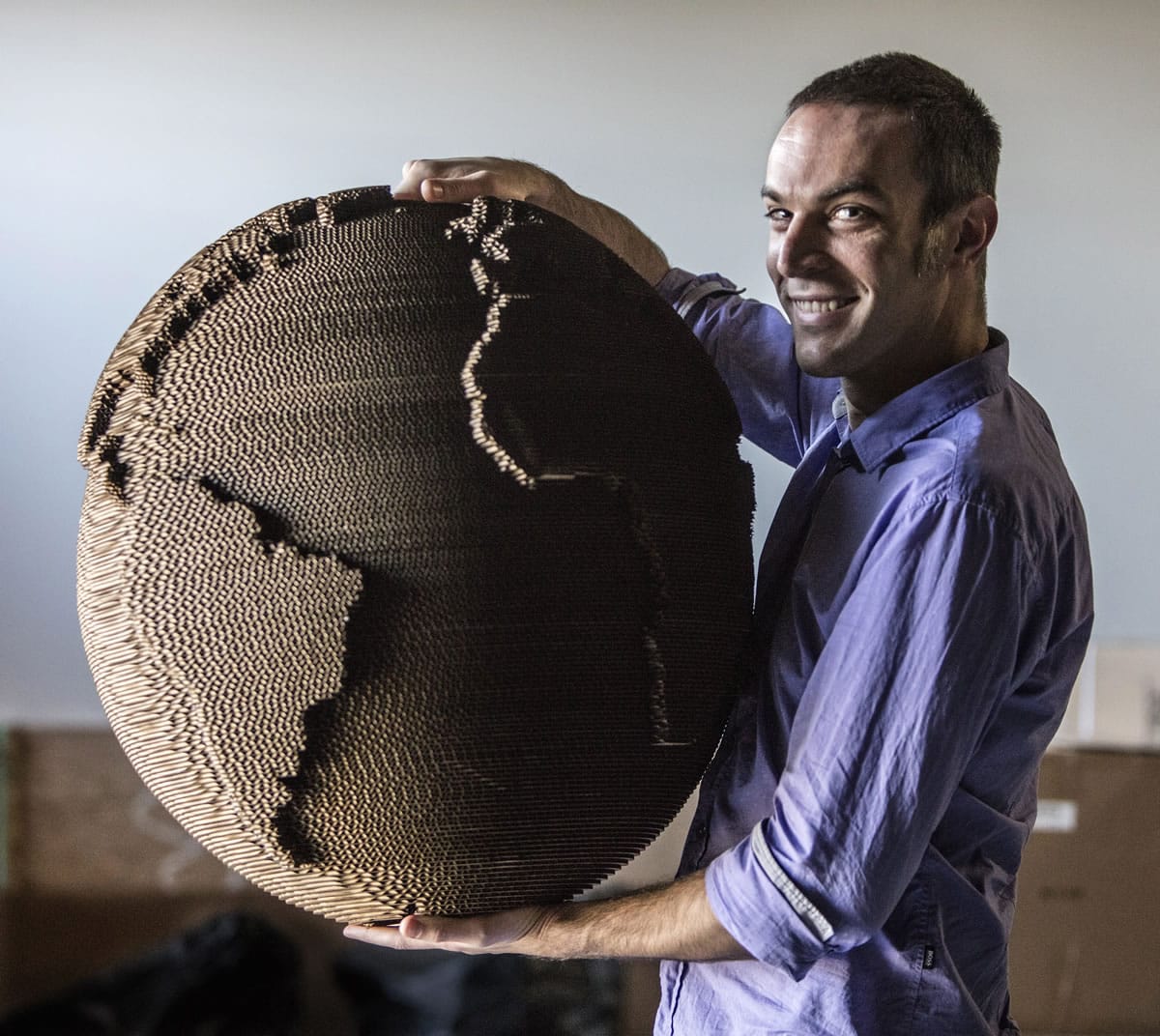 Dan Shapiro founded Glowforge, which makes 3-D laser printers for designers. He&#039;s holding a recycled cardboard lamp made with the printer.