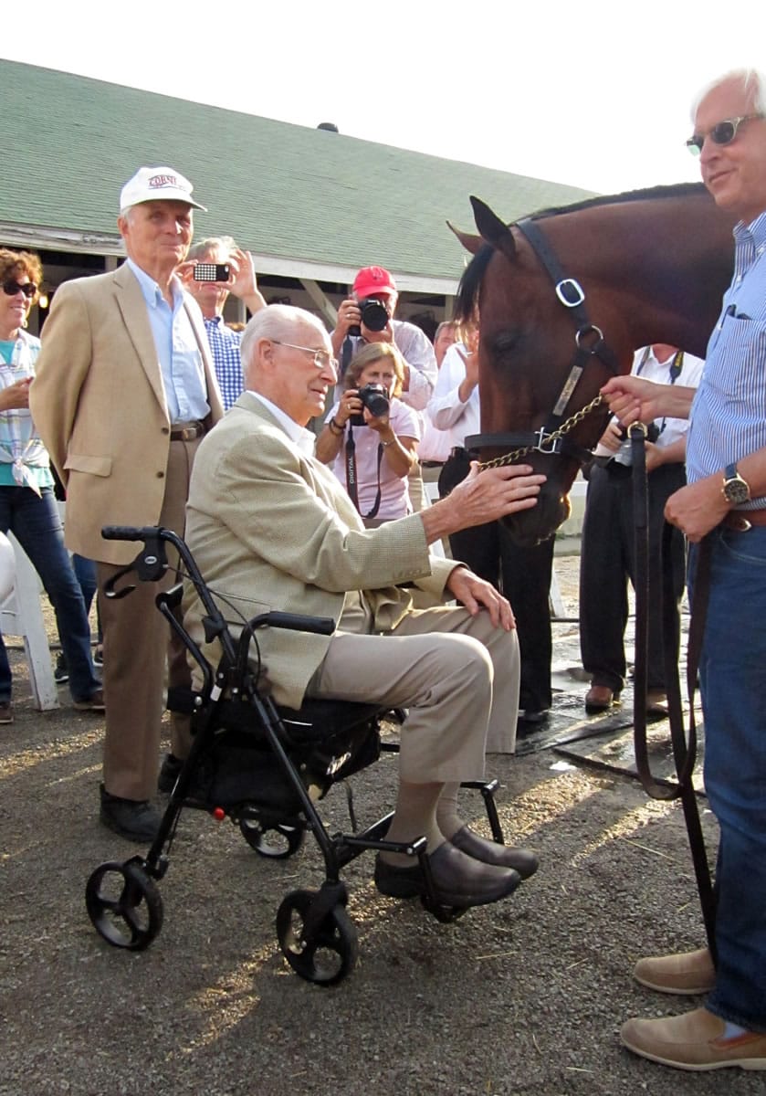 William McGee, 98, who has seen six Triple Crown winners, pats American Pharoah in June. The 2015 Triple Crown winner is scheduled to make the last start of his racing career on Saturday. As a boy, McGee attended what then was Shumway Junior High in Vancouver. (Gary B.