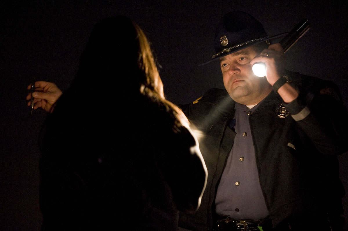 WSP Trooper Ben Taylor administers a field sobriety test to a driver who nearly crashed her car into a concrete barrier on state Highway 500 in December 2011. The driver was arrested on suspicion of DUI.