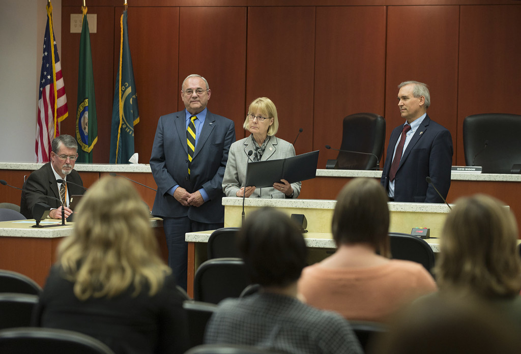 Acting County Manager Mark McCauley, from left, listens as Tom Mielke, Jeanne Stewart and David Madore of the Board of County Councilors issue a proclamation for disability employment awareness month Oct. 6 at the Clark County Public Service Center.