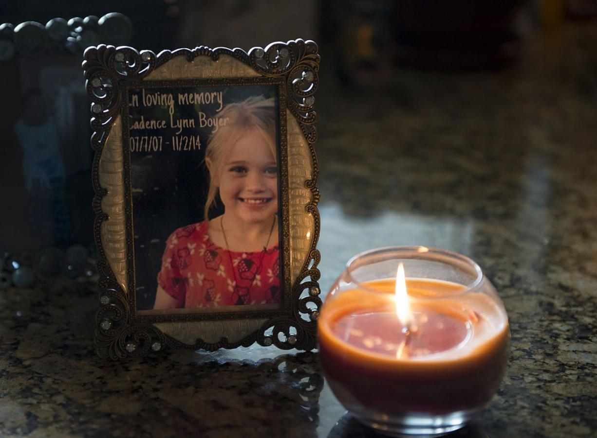 A candle illuminates a framed photo of Cadence Boyer at her grandmother&#039;s house in Vancouver. Cadence was struck by an allegedly intoxicated driver on Halloween night last year and died two days later.