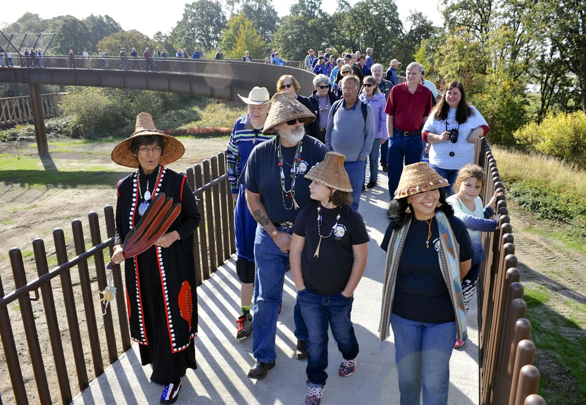 Cowlitz spiritual leader Tanna Engdahl, left, and Chinook vice chairman Sam Robinson -- with granddaughter Destiny and wife Mildred -- have the honor of being first across the new universal-access bridge that now spans the railroad tracks at the Ridgefield National Wildlife Refuge&#039;s northern Carty Unit.