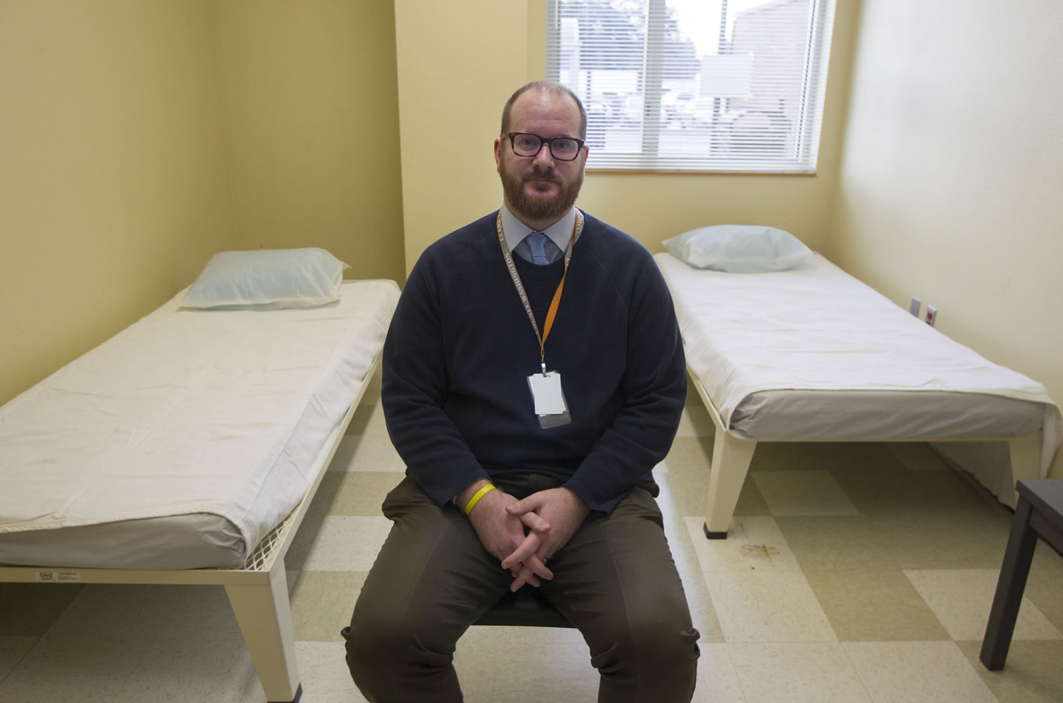 Lifeline Connections executive director Jared Sanford sits in a remodeled bedroom in the new &quot;sobering center&quot; on the ground floor of the Center for Community Health.