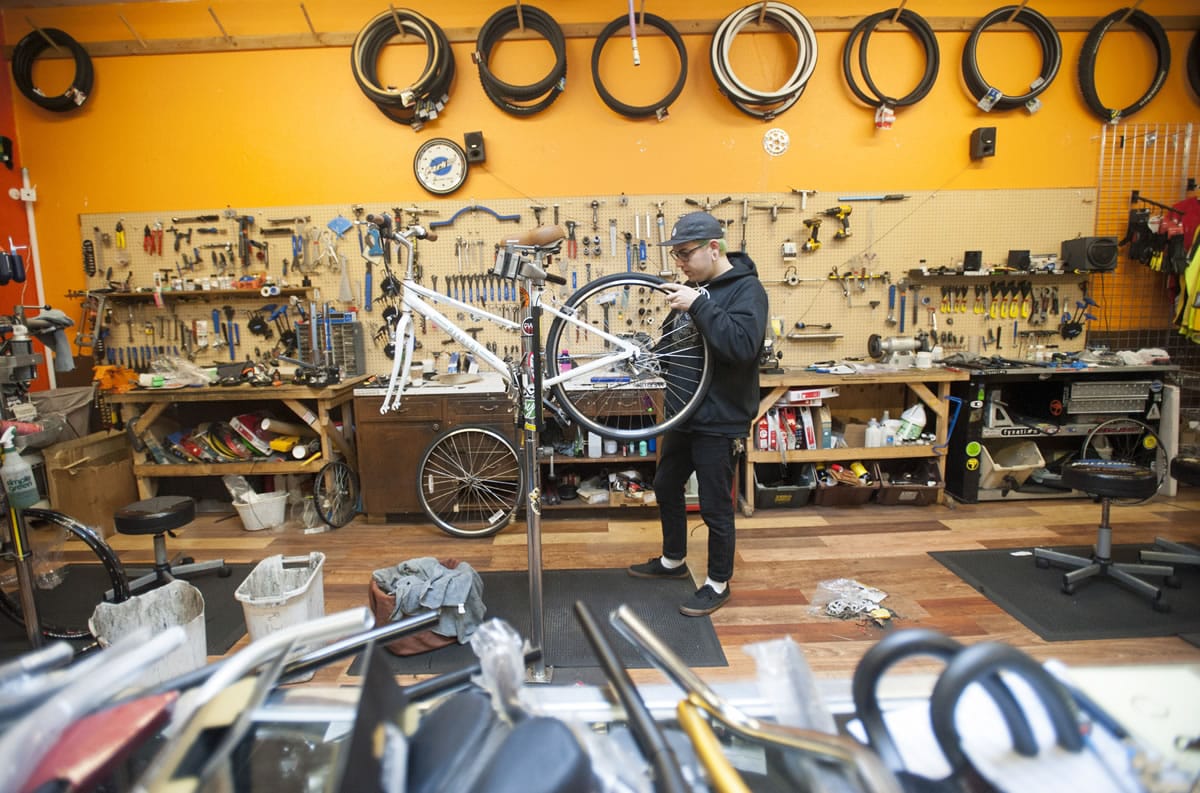 Bicycle mechanic Zach Dane works on a bike at Bad Monkey Bikes in Vancouver.