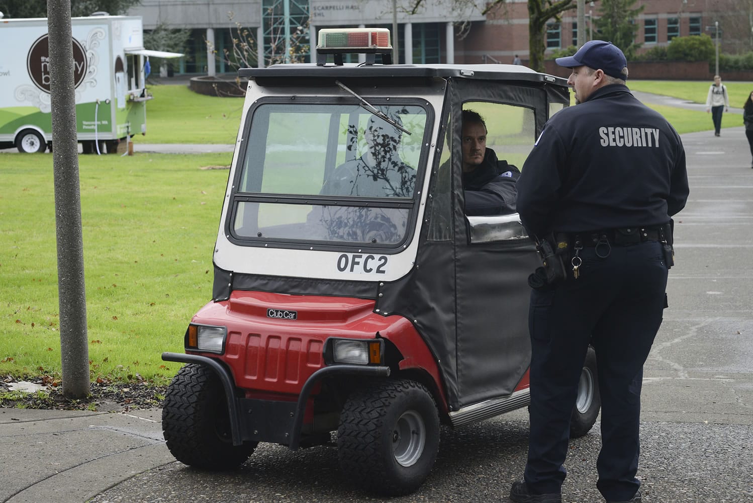 Unarmed security guards Benedetto Vesperini, in the golf cart, and Damon Grady patrol the Clark College campus in December.