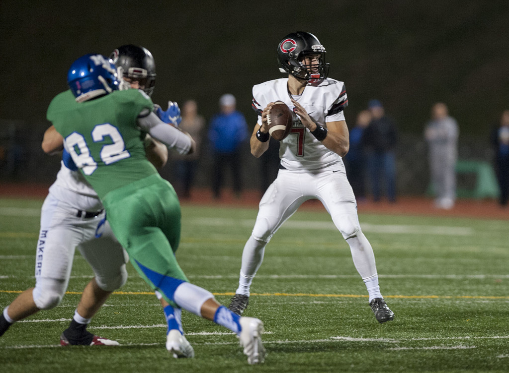 Camas quarterback Liam Fitzgerald (7) looks for an open teammate downfield in the first quarter Friday night, Oct. 23, 2015 at McKenzie Stadium.