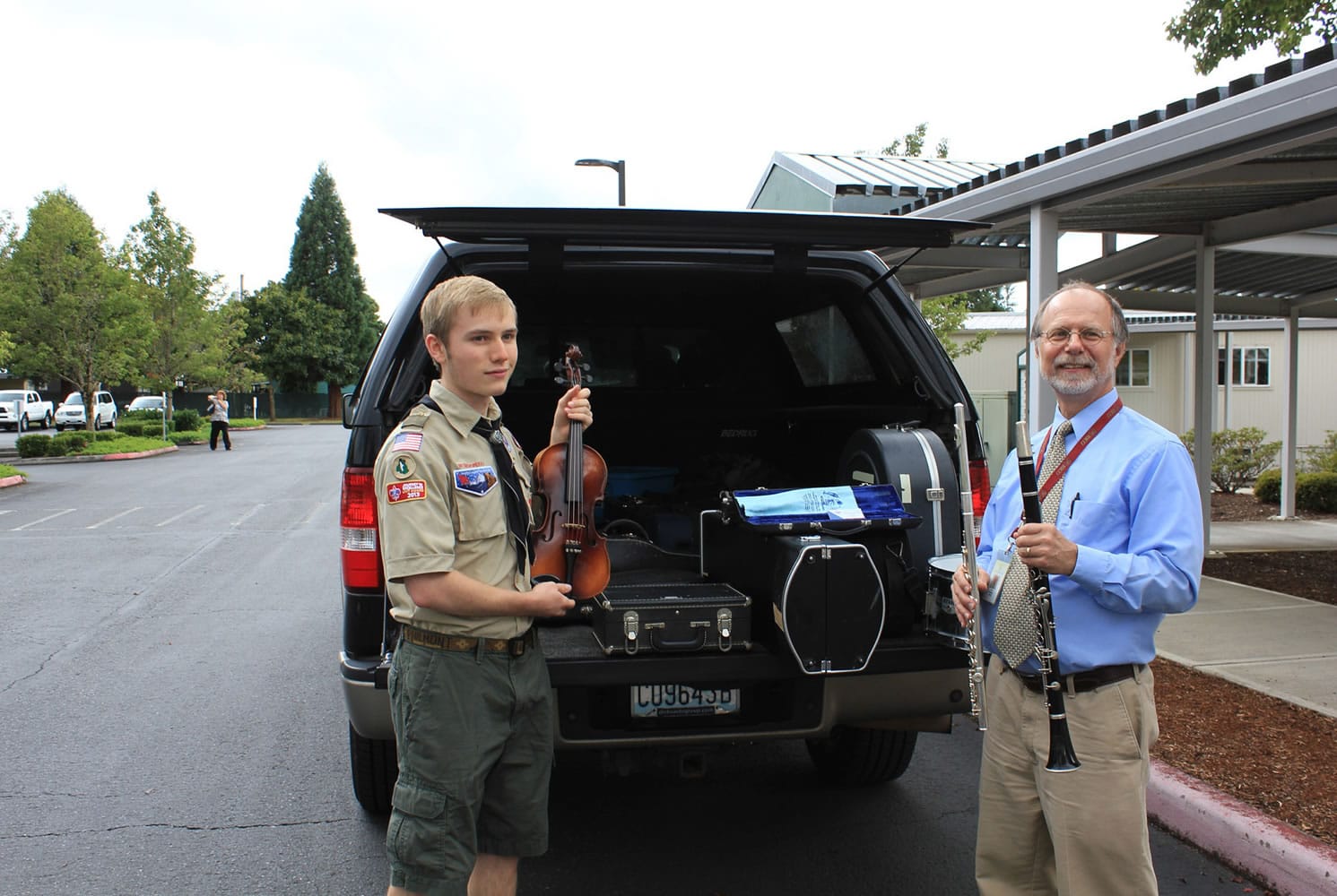 Mill Plain: Eagle Scout Clayton Wahlstrom, left, of Troop 462 presents the 35 instruments he collected to Don Nelson, manager of Evergreen Public Schools' fine and performing arts program.