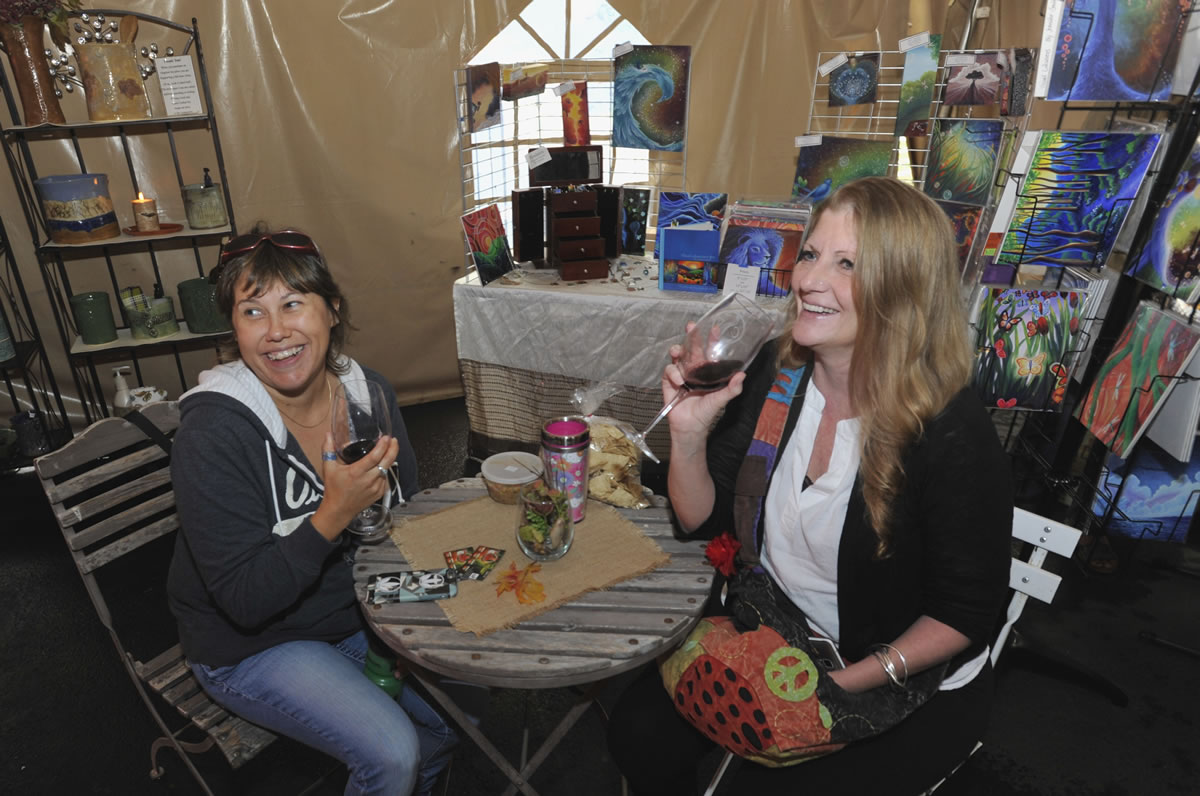 Belinda Cochran, left, and CeCe Tangocci plan their wine purchases Sunday at Confluence Vineyards &amp; Winery in Ridgefield. Cochran said she likely wouldn&#039;t leave without buying a bottle of a wine blend called Red Velvet.