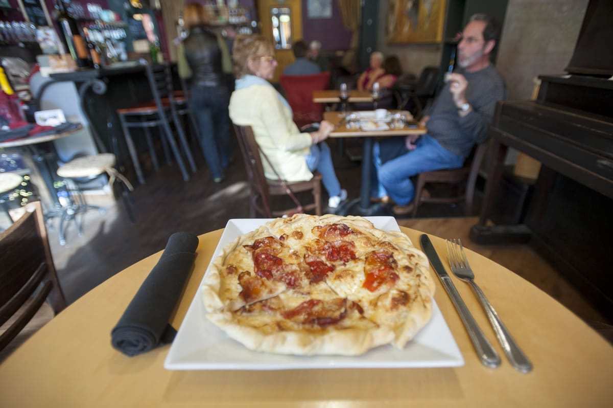 An Alsatian tart flambe at Niche Wine Bar in downtown Vancouver offered as one of the restaurant&#039;s Wild Card menu items included French pastry dough topped with creme fraiche and cheese, with Gruyere, smoked prosciutto and Hungarian peppers.
