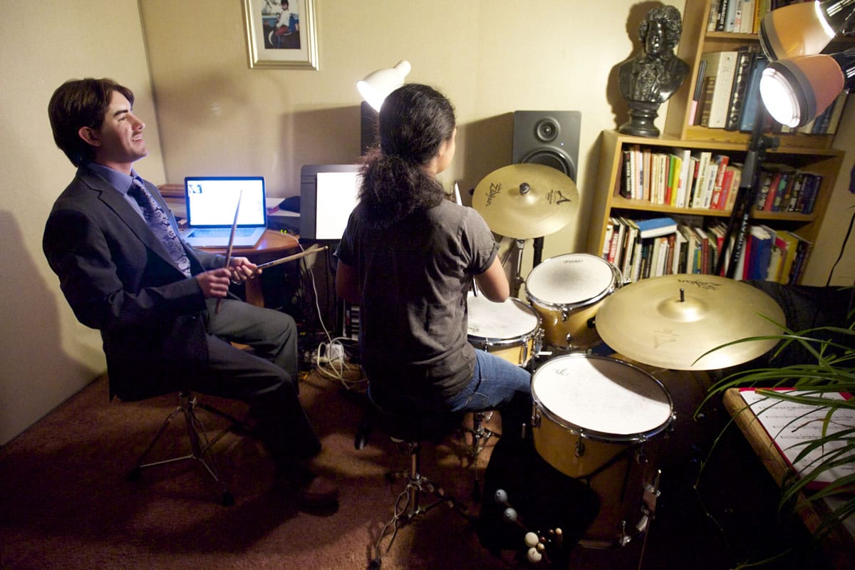 Photos by Steven Lane/The Columbian
Vaughn Brown, left, a deaf-blind percussionist, teaches his student Leilani Towner, seated at the drum kit. After graduating from Washington State School for the Blind, the percussionist graduated from Berklee College of Music in Boston.
