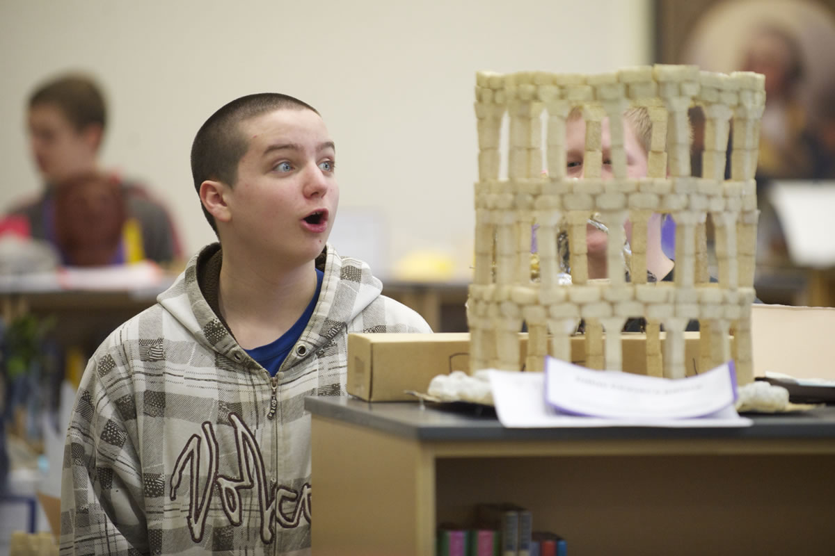Photos by Steven Lane/The Columbian
Liberty Middle School seventh-grader Brighton Ford looks at a foam model of ancient Roman architecture.