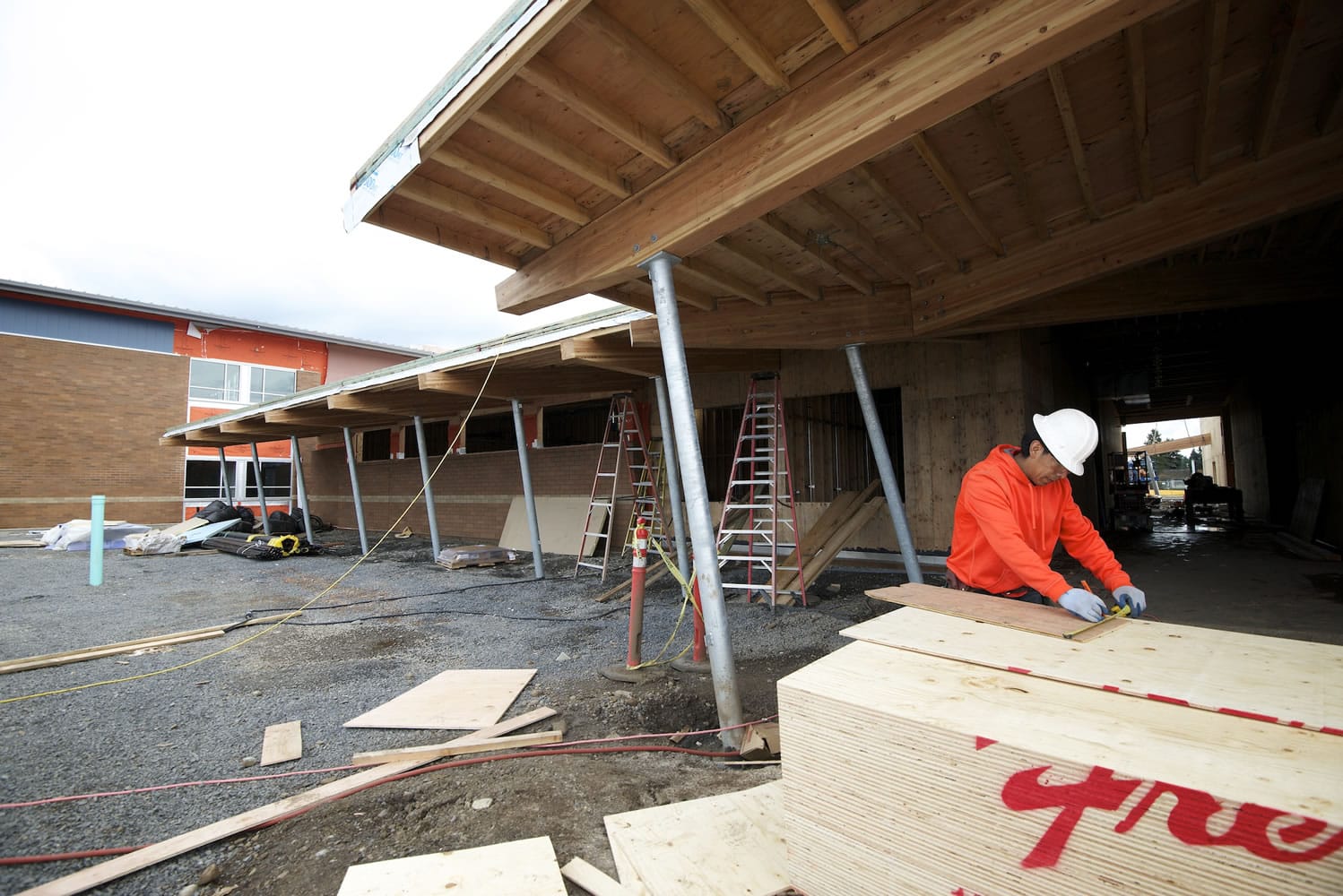 Ocotlan Neria Corona, with Carpentry Plus, works on framing at Crestline Elementary on Monday in Vancouver.