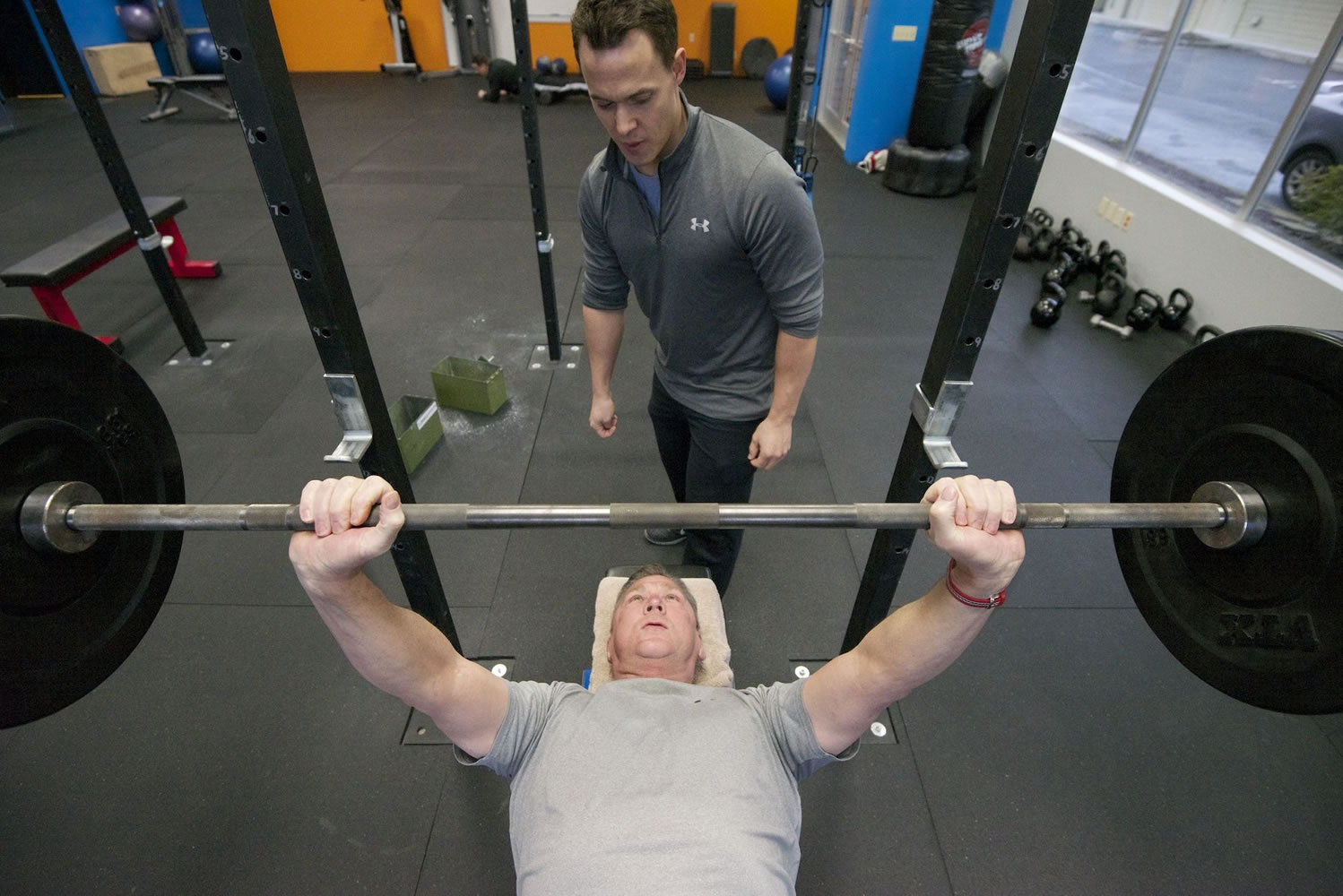 David Williams, 61, of Hockinson lifts weights under the guidance of Brian Stecker, a personal trainer who specializes in fitness for baby boomers, at his east Vancouver training studio.