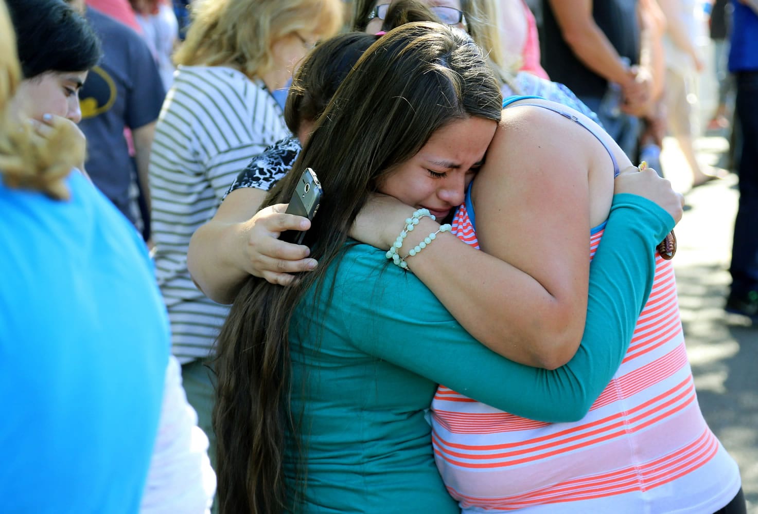 Jessica Vazquez, left, hugs her aunt Leticia Acaraz as they await word on Acaraz's daughter at the local fairgrounds after a shooting at Umpqua Community College in Roseburg, Ore., on Thursday, Oct. 1, 2015.