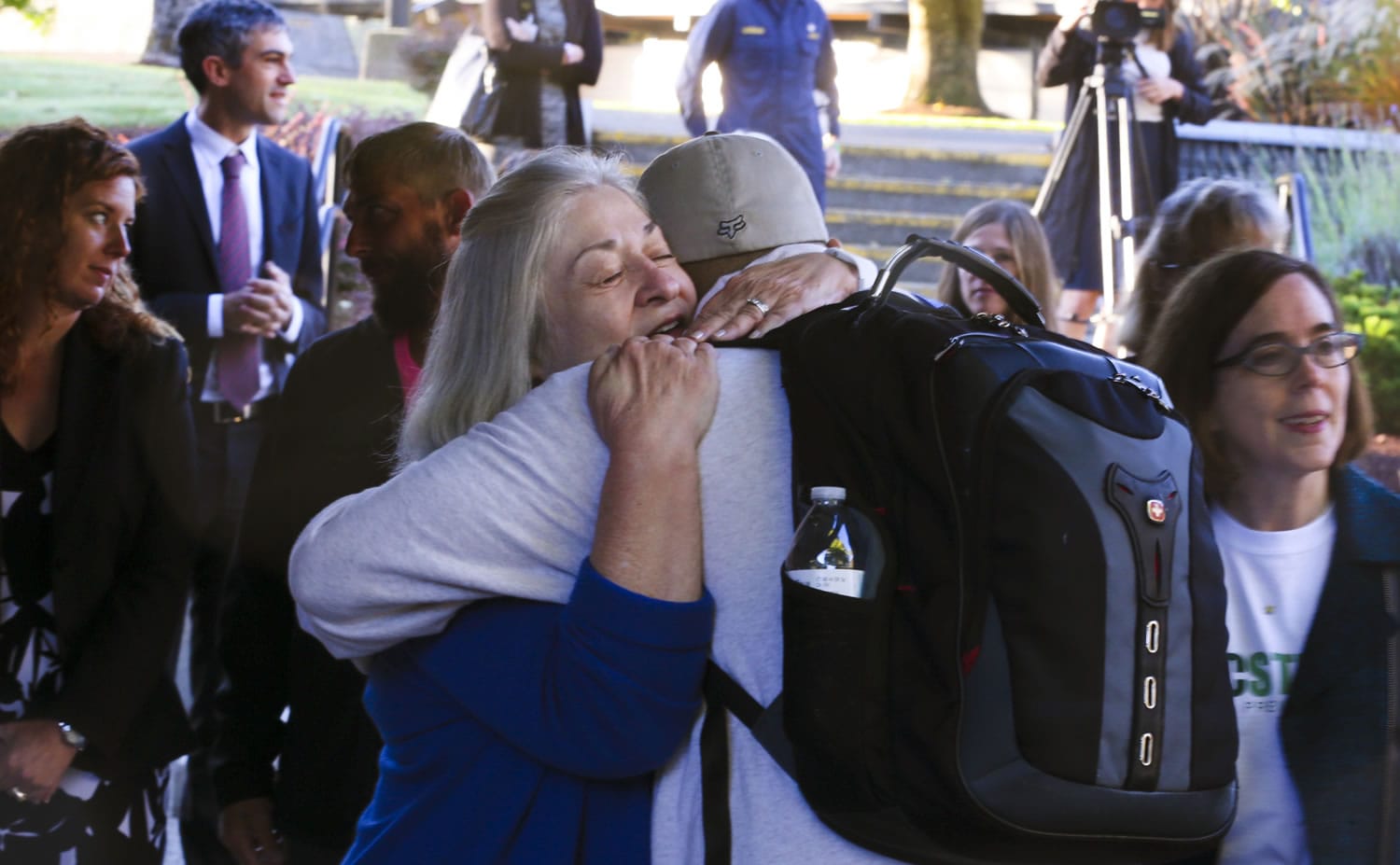Umpqua Community College interim President Rita Cavin hugs an unidentified student on campus as the school reopens, Oct. 12 after being closed since the multiple fatality shooting on Oct. 1, in Roseburg, Ore.