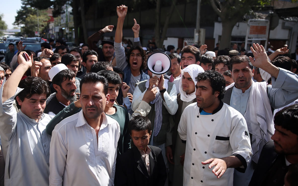 Afghan protesters shout slogans during a demonstration against government, in Kabul, Afghanistan, on Wednesday. An Afghan official says government troops have regained control of the main square in Kunduz, a strategic northern city briefly seized by Taliban insurgents last week.