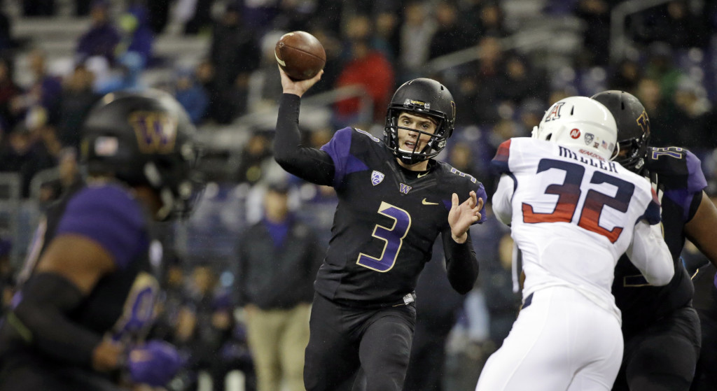 Washington quarterback Jake Browning (3) throws a touchdown pass to Joshua Perkins, left, against Arizona in the first half an NCAA college football game Saturday, Oct. 31, 2015, in Seattle.