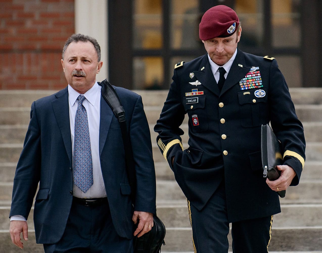 Brig. Gen. Jeffrey Sinclair, right, leaves the courthouse March 4 with his lawyers, Richard Scheff, left, and Ellen C.