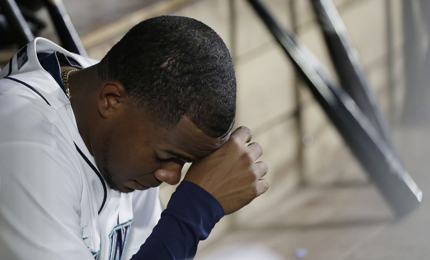 Seattle Mariners starting pitcher Roenis Elias sits in the dugout after being pulled from a baseball game against the Oakland Athletics in the third inning, Saturday, Oct. 3, 2015, in Seattle. (AP Photo/Ted S.