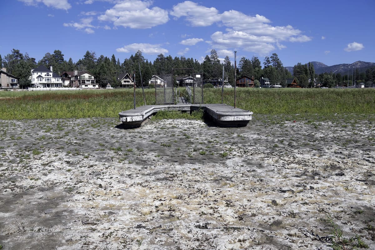 A boat dock by the lake bed where water has dried due to the drought at Big Bear Lake, Calif. A state water official said Californians have met a mandate to save water for a third consecutive month during the grinding drought. The State Water Resources Control Board on Thursday, Oct. 1 will release statewide conservation figures for August.