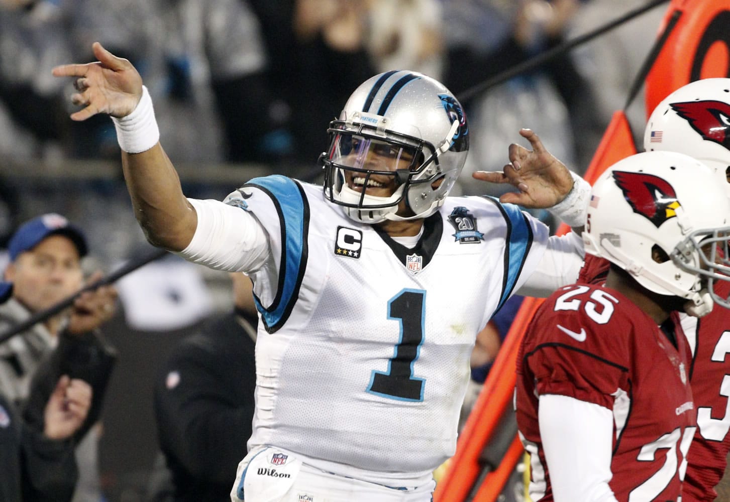 Carolina Panthers' Cam Newton (1) signals after making a first down against the Arizona Cardinals in the first half  in Charlotte, N.C., Saturday, Jan. 3, 2015.