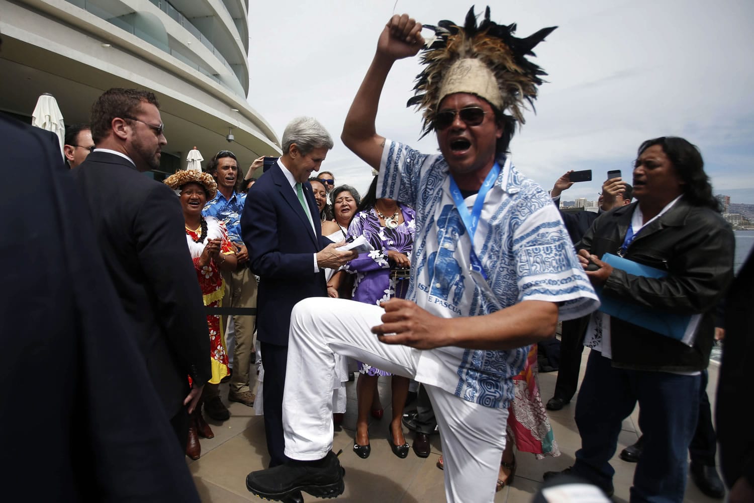 A man from Easter Island dances as U.S. Secretary of State John Kerry, behind, is gifted an Easter Island flag, on the sidelines of the Our Ocean international conference on marine protection in Vina del Mar, Chile, on Monday. President Barack Obama declared new marine sanctuaries in Lake Michigan and the tidal waters of Maryland on Monday, while Chile blocked off a vast expanse of the Pacific Ocean near the world-famous Easter Island from commercial fishing and oil and gas exploration.