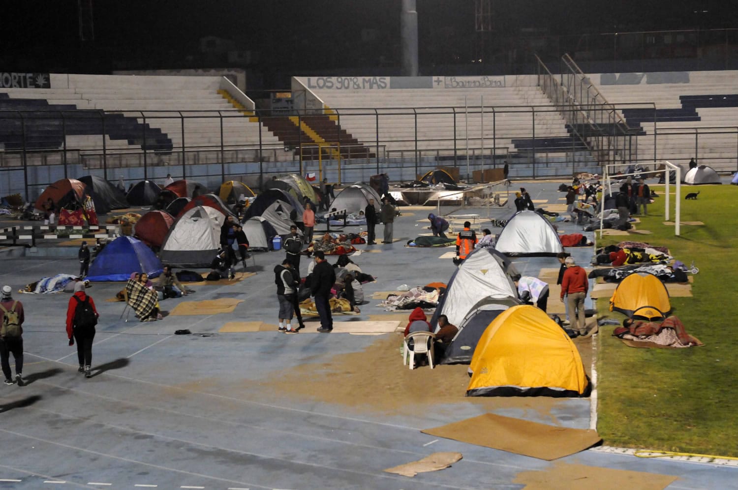 Residents of the city of Iquique spend a second sleepless night in the city's football Stadium in Iquique, Chile, on Wednesday.