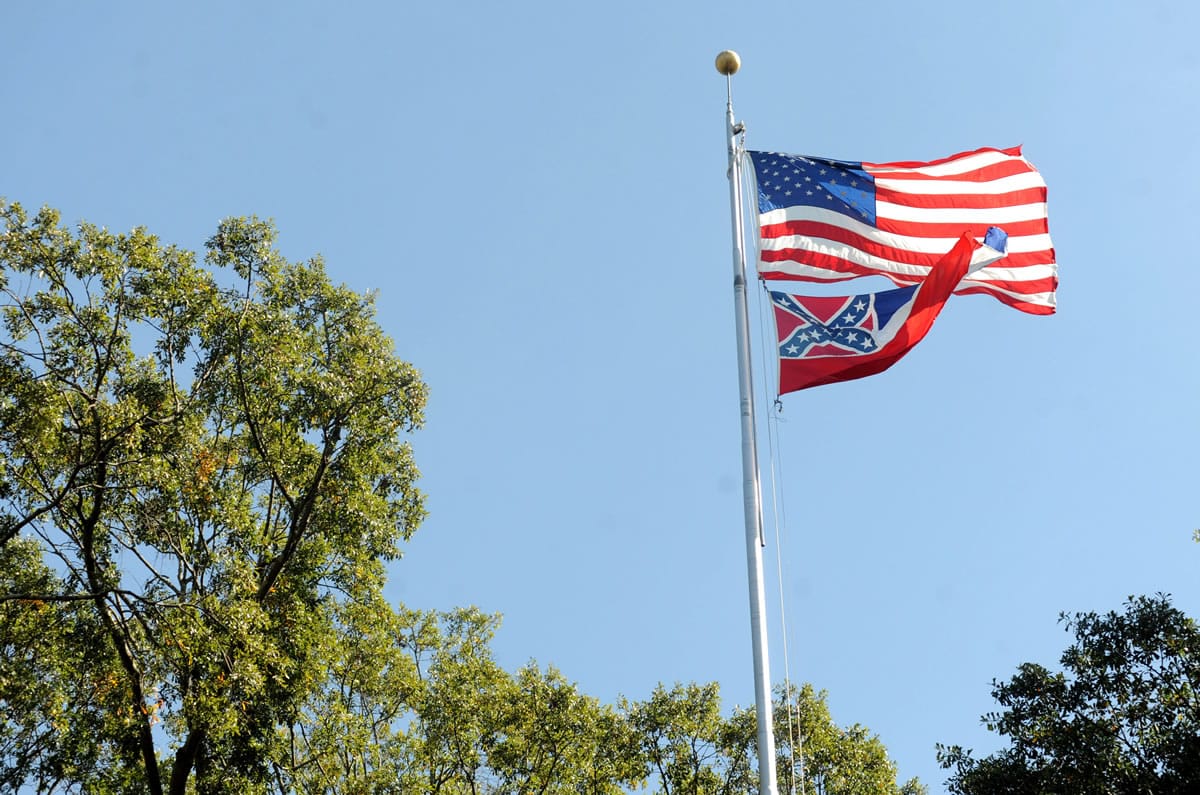 The Mississippi state flag and U.S. flag fly in the Circle on campus at the University of Mississippi in Oxford, Miss. The state flag was removed Monday days after the student senate, the faculty senate and other groups adopted a student-led resolution calling for removal of the banner from campus.