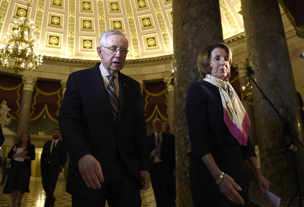 House Democratic Leader Nancy Pelosi of California, right, and Senate Minority Leader Harry Reid of Nevada walk to talk to reporters Wednesday on Capitol Hill in Washington about the passage of a budget by the House. The Senate passed the budget early Friday morning.