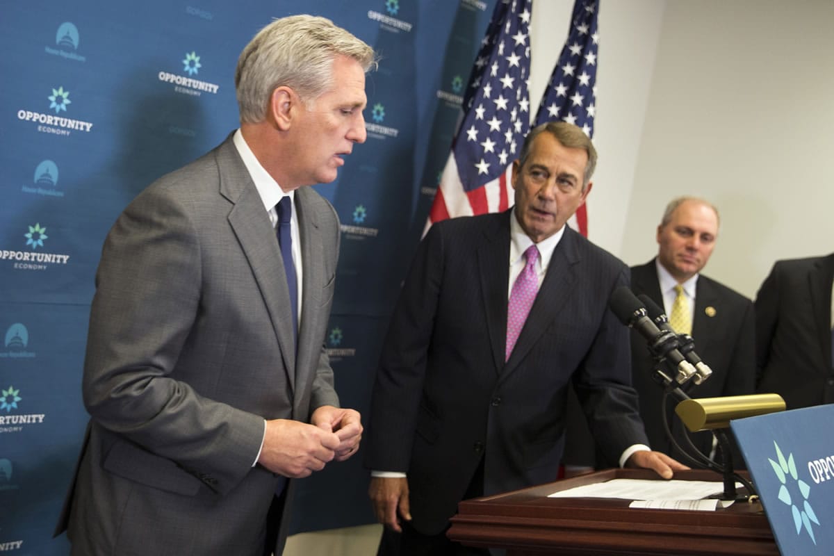 House Majority Leader Kevin McCarthy of Calif., left, accompanied by outgoing House Speaker John Boehner of Ohio, center, and House Majority Whip Steve Scalise of La. speaks during a new conference on Capitol Hill in Washington on Wednesday following the weekly House Republican conference meeting. The House?s most hard-edged conservatives are trying to keep McCarthy from inheriting the Speaker post from Boehner once he steps down.