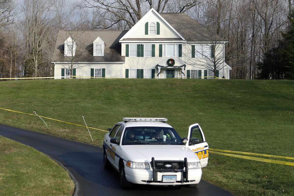A police cruiser sits in the driveway as crime scene tape surrounds the home of Nancy Lanza in Newtown, Conn., on Dec. 18, 2012/ Nancy Lanza was killed there by her son Adam Lanza, before he forced his way into Sandy Hook Elementary School on Dec.